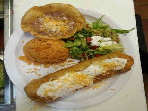 Gudalajara Restaurant's chimichanga with yellow rice, salad, and a tortilla served on a white plate