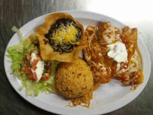 Gudalajara Restaurant's three enchiladas with sauce on top, yellow rice, salad, and a stuffed tortilla with cheese.